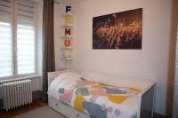 a bedroom with a bed and a picture on the wall at Le petit Gambetta in Belfort