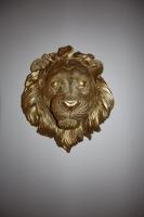 a bronze lion head on a white wall at Le petit Gambetta in Belfort