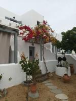 a white building with plants in front of it at Theofanis Studios in Agia Anna Naxos
