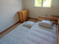 a bedroom with two twin beds and a dresser at La petite trapue in Desvres