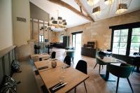 a restaurant with tables and chairs in a room at La Métairie De Terrefort in Bouliac