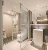 a bathroom with a toilet and a glass shower at Orange Hotel - Ximen, Taipei in Taipei