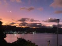 a view of a large body of water at sunset at Incredible Views! Luxurious Studio &amp; Outdoor Living in Wellington