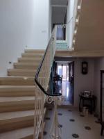 a staircase in a house with a chair next to it at The Luxury Home - Next to airport! in Kirkop