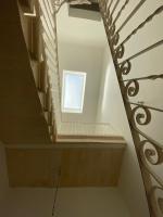 a stairway with a window in a stair case at The Luxury Home - Next to airport! in Kirkop