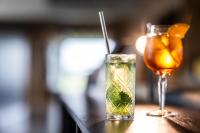 a drink sitting on a table next to a glass at Airport Hotel, Billund in Billund