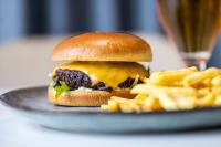 a cheeseburger and french fries on a plate at Airport Hotel, Billund in Billund