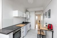 a kitchen with white cabinets and a wooden counter top at Vue mer &#47; Jaurès-Centre-Ville &#47; Appart Lumineux in Brest