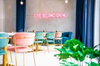 a group of chairs and a table in a room at The Base Berlin ONE in Berlin