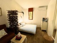 a small room with a bed and a wine rack at Camping Sunêlia la Clémentine in Cendras
