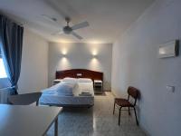 Posteľ alebo postele v izbe v ubytovaní Hostal la Embajada