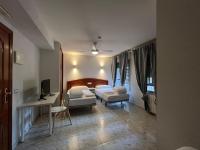 Posteľ alebo postele v izbe v ubytovaní Hostal la Embajada