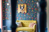 a yellow couch in a room with a painting of a dog at Maison Alfred et Agatha in Pleudihen-sur-Rance