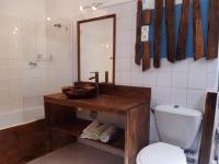 a bathroom with a toilet and a sink and a mirror at La ferme de Manon in Montferrat