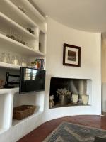a living room with a tv and a fireplace at Sur le Pont in Vaison-la-Romaine