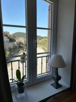 a room with a window with a lamp and a view at Sur le Pont in Vaison-la-Romaine