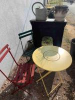 a table and two chairs sitting next to a grill at LE DEPOT appartement du port à Champvert in Champvert