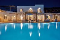 a villa with a swimming pool at night at Ubud Mykonos in Agios Ioannis Mykonos