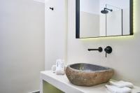 a bathroom with a stone sink on a counter at Ubud Mykonos in Agios Ioannis Mykonos