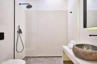 a bathroom with a sink and a shower at Ubud Mykonos in Agios Ioannis Mykonos