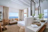 a bedroom with a bed and a living room at Ubud Mykonos in Agios Ioannis Mykonos