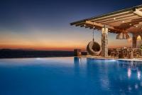 a swimming pool in front of a villa at Ubud Mykonos in Agios Ioannis Mykonos
