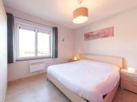 a bedroom with a white bed and a window at Apartment Zeebries by Interhome in Bredene