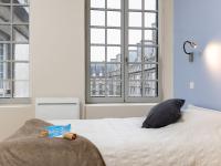 a bedroom with a bed with two teddy bears on it at Apartment Plasenn by Interhome in Saint Malo
