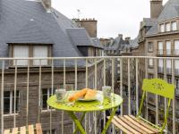 a plate of croissants on a table on a balcony at Apartment Plasenn by Interhome in Saint Malo