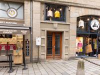 a building with several shops on a city street at Apartment Plasenn by Interhome in Saint Malo