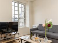 a living room with a couch and a table at Apartment Plasenn by Interhome in Saint Malo