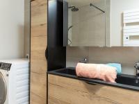 a bathroom with a sink and a washing machine at Apartment Plasenn by Interhome in Saint Malo