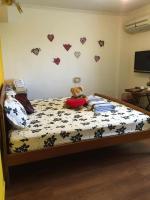 a teddy bear sitting on a bed with hearts on the wall at Winter&#39;s Love in Wujie