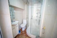 a bathroom with a shower and a toilet and a sink at ARI Apartments in Krašići