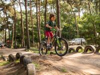 a young boy riding a bike on a dirt road at De Goolder in Bocholt