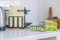 a kitchen counter with a coffee maker and some food at Studio front de mer en centre-ville de Cabourg in Cabourg