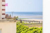 a view of the beach from the balcony of a building at Studio front de mer en centre-ville de Cabourg in Cabourg