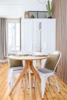 a dining room with a table and two chairs at Studio front de mer en centre-ville de Cabourg in Cabourg