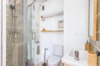 a bathroom with a shower and a toilet and a sink at Studio front de mer en centre-ville de Cabourg in Cabourg