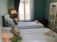 a hotel room with two beds and a window at Hypercentre - Coté Chateau in Blois