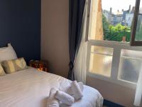 a bedroom with a bed next to a window at Hypercentre - Coté Chateau in Blois