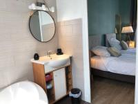 a bathroom with a sink and a mirror and a bed at Hypercentre - Coté Chateau in Blois