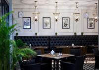 ein Esszimmer mit Tischen, Stühlen und Lichtern in der Unterkunft Le Thatluang D'oR Boutique Hotel in Vientiane