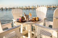 a table with food and chairs on the water at Playa Largo Resort & Spa, Autograph Collection in Key Largo