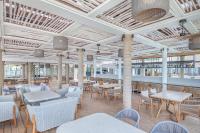 a dining room with tables and chairs and tablesktop at Sheraton Fiji Golf & Beach Resort in Denarau