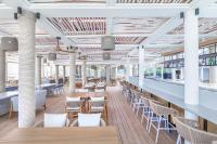 a restaurant with white columns and tables and chairs at Sheraton Fiji Golf & Beach Resort in Denarau