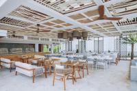 a restaurant with tables and chairs in a room at Sheraton Fiji Golf & Beach Resort in Denarau