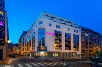 a large white building with a pink sign on it at Moxy Paris Bastille in Paris