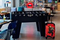 a large black table with a suitcase in a room at Moxy Paris Bastille in Paris