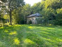 an old house in the middle of a field at Les Murmures du Moulin in Tence